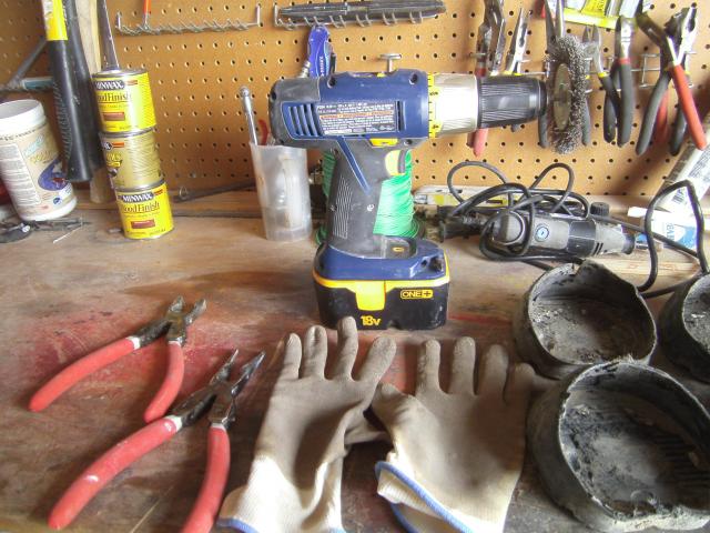 Gloves, pliers and large drill with wire brush attachment